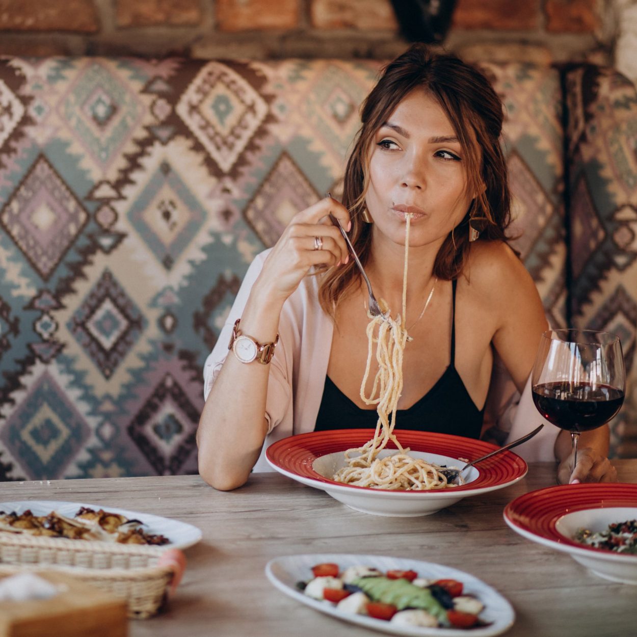 Woman eating pasta in an italian restaurant